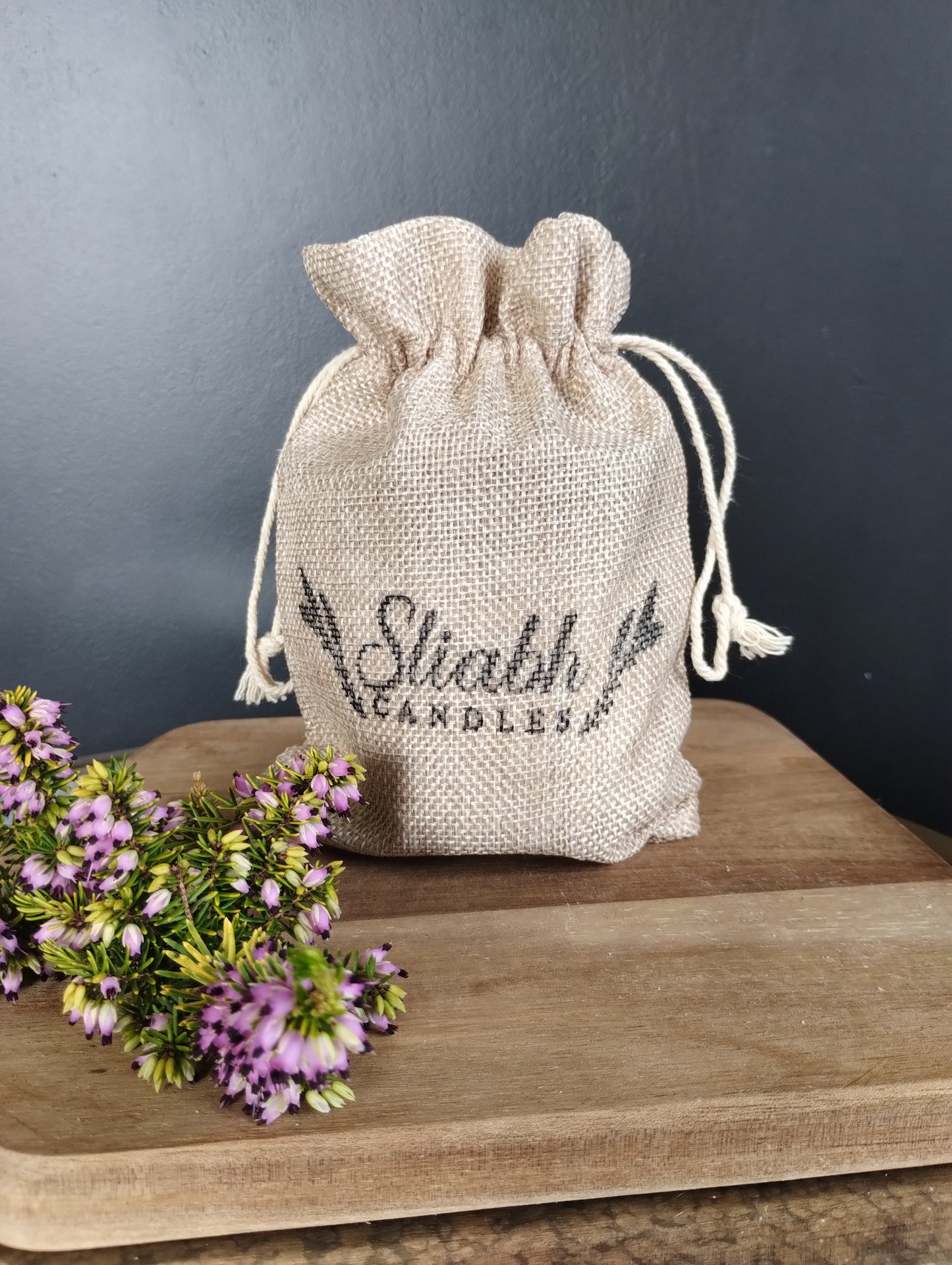 Jute hessian drawstring gift bag with Sliabh Candles stamped on the front. All of our candles presented in it.