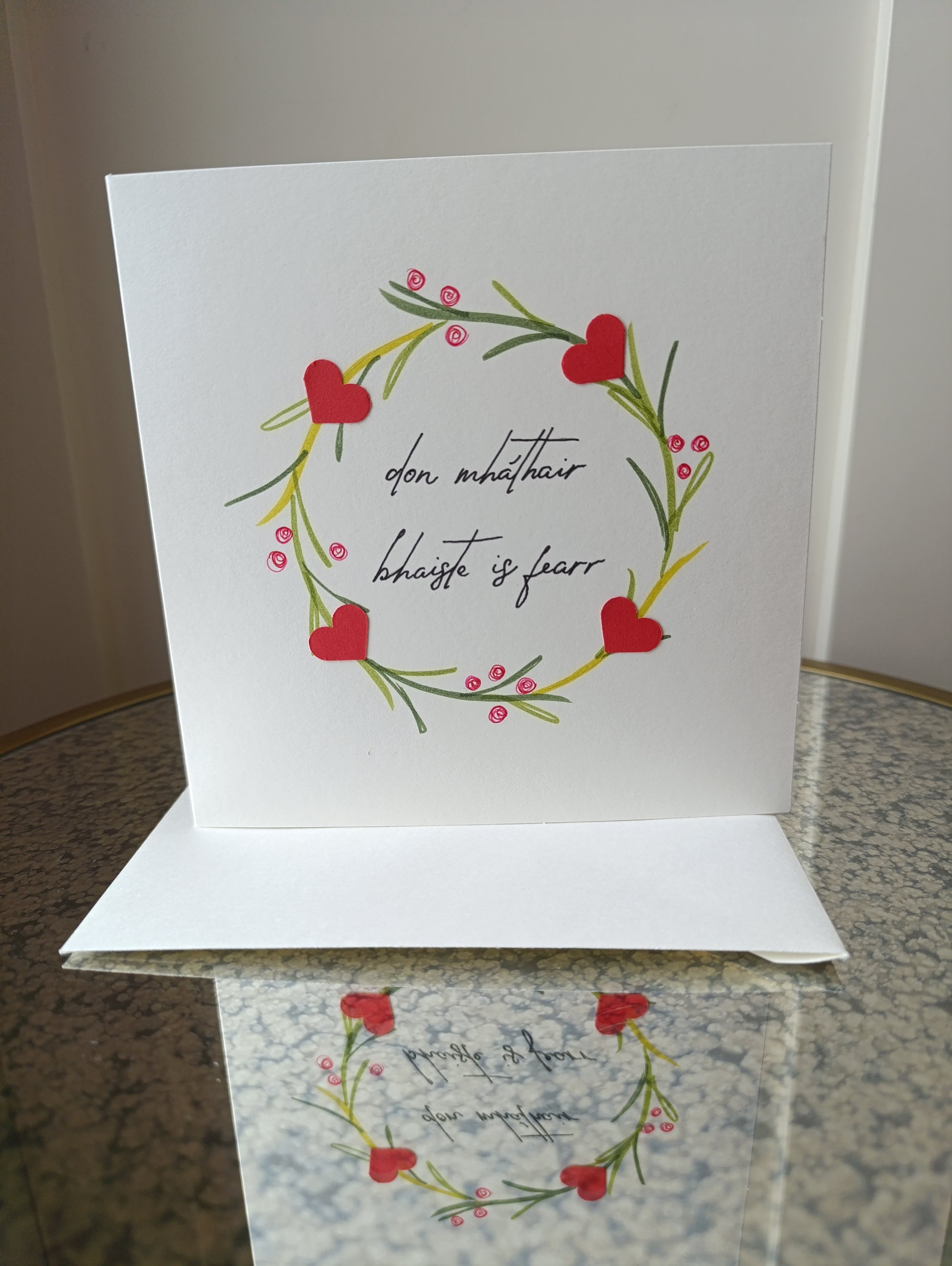 Greeting card with floral design and text on a surface