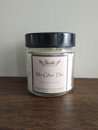 'Mo Ghrá Thú' | 'My Love'  A beautiful gift for that special someone for Valentine's Day.  The perfect Irish gift for any occasion. Sliabh Candles are hand-poured in small batches in Connemara. Each candle has an Irish 'Seanfhocal' (proverb) or saying. They are made from 100% Soy Wax with cotton and linen wicks. The candles are made in a recyclable glass jar. All candles come in a jute drawstring gift bag.