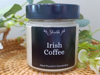 Jar of 'Irish Coffee'  scented soy wax candle with a black lid on a woven surface. Irish handmade candle. Handpoured in Connemara. 