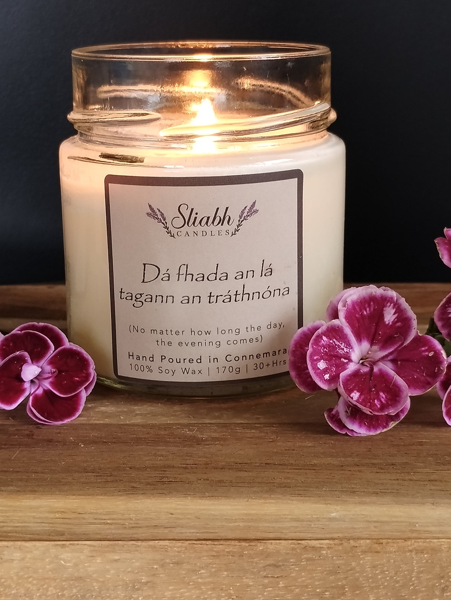Soy Wax Candle with positive affirmation saying- No matter how long the day, the evening comes'  glass jar, black lid with label. 