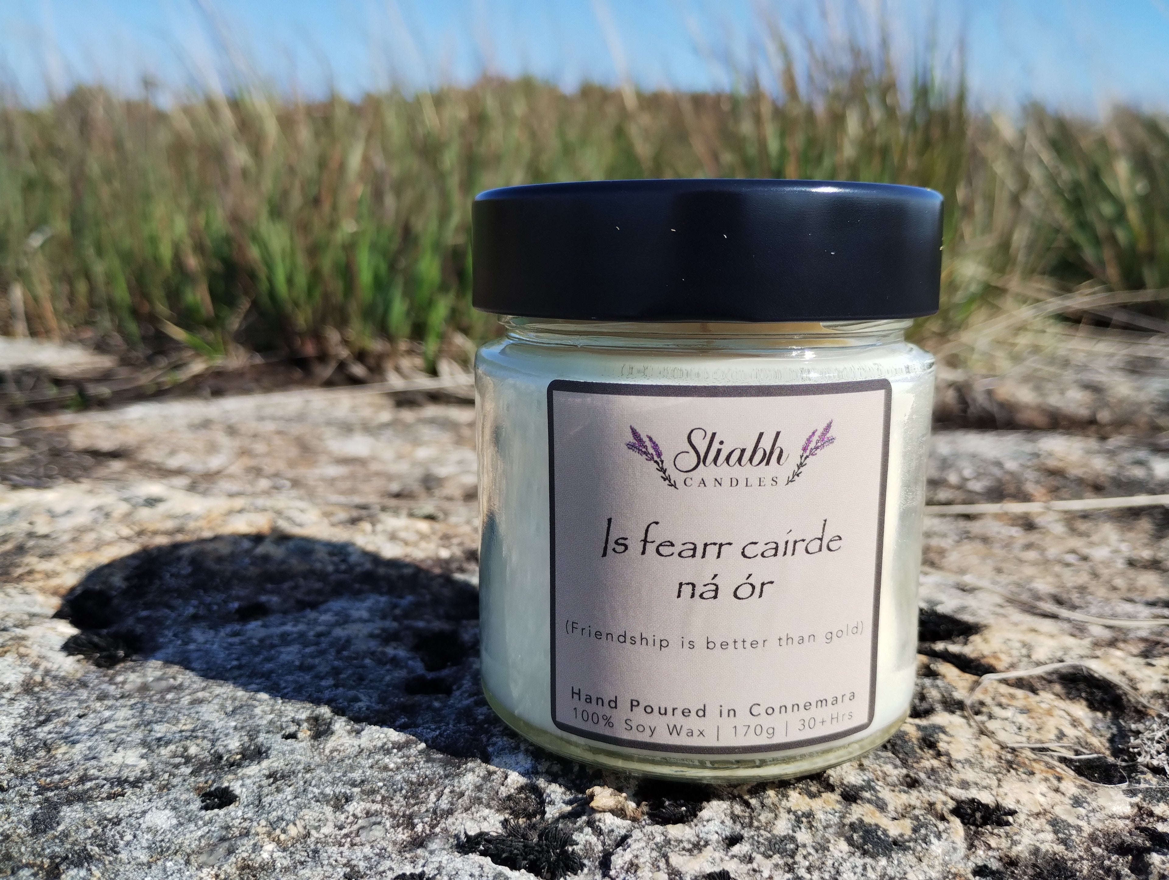 Candle jar from Sliabh Candles. Soy wax candle with old Irish saying on it. Is Fearr Cairde ná ór - Friendhship is better than gold - made with 100% soy wax. Handmade in Connemara. 
